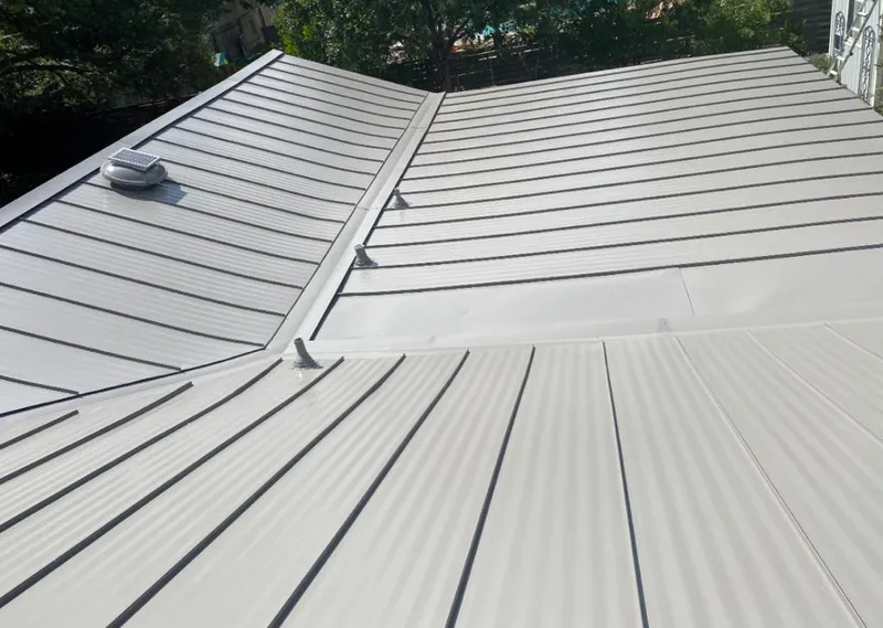 Solar attic fan installed on a metal roof for Roof Ventilation in Mahomet